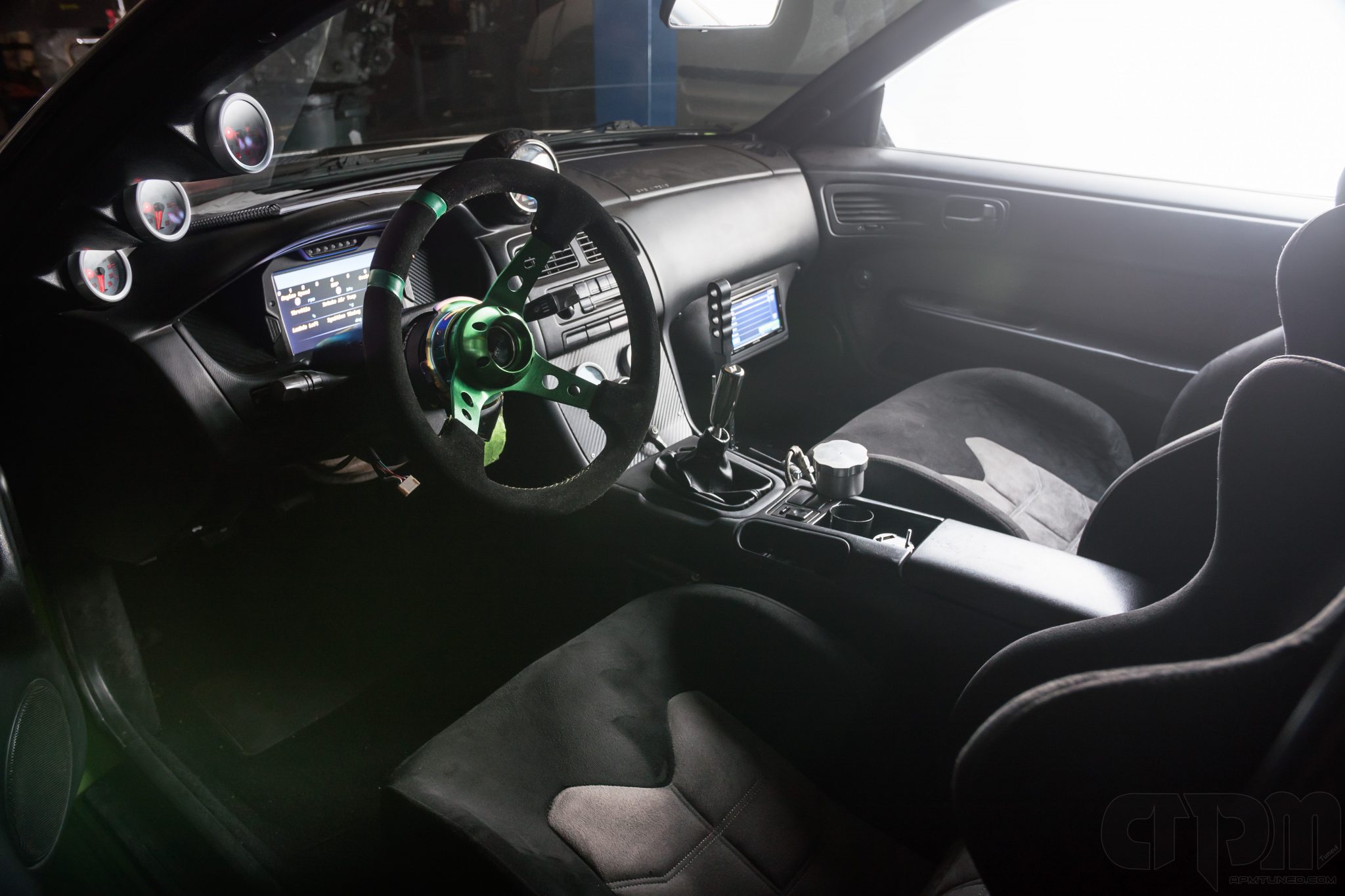 Interior of 240sx drift car with custom installed AEM display and AEM Gauges